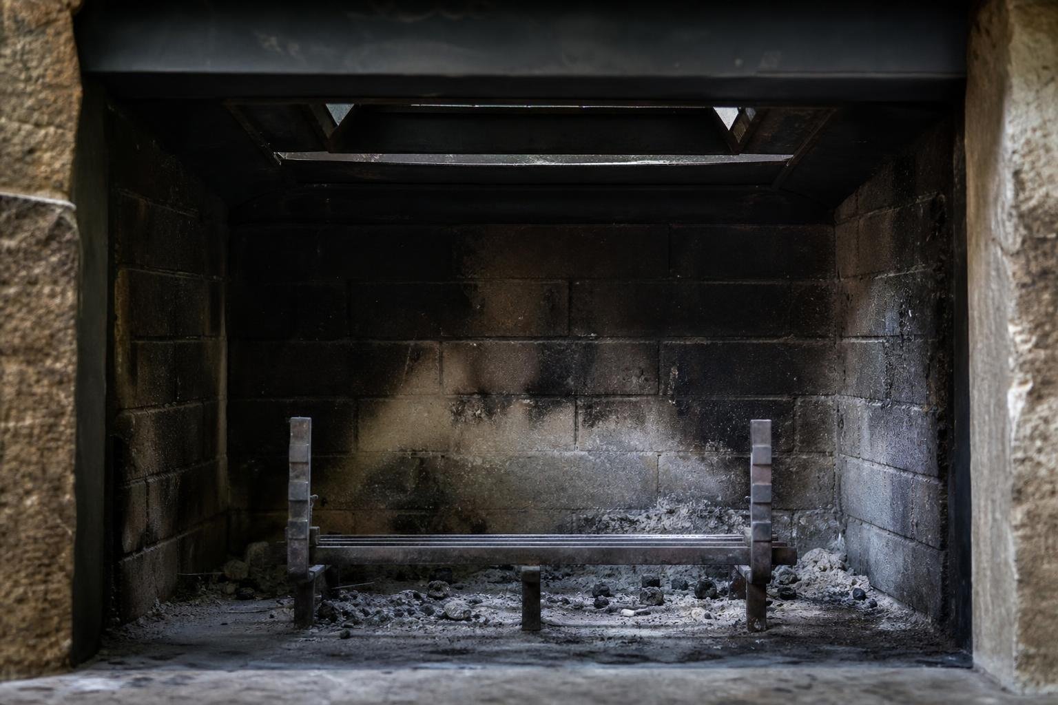 Interior of a fireplace firebox with sooty residue